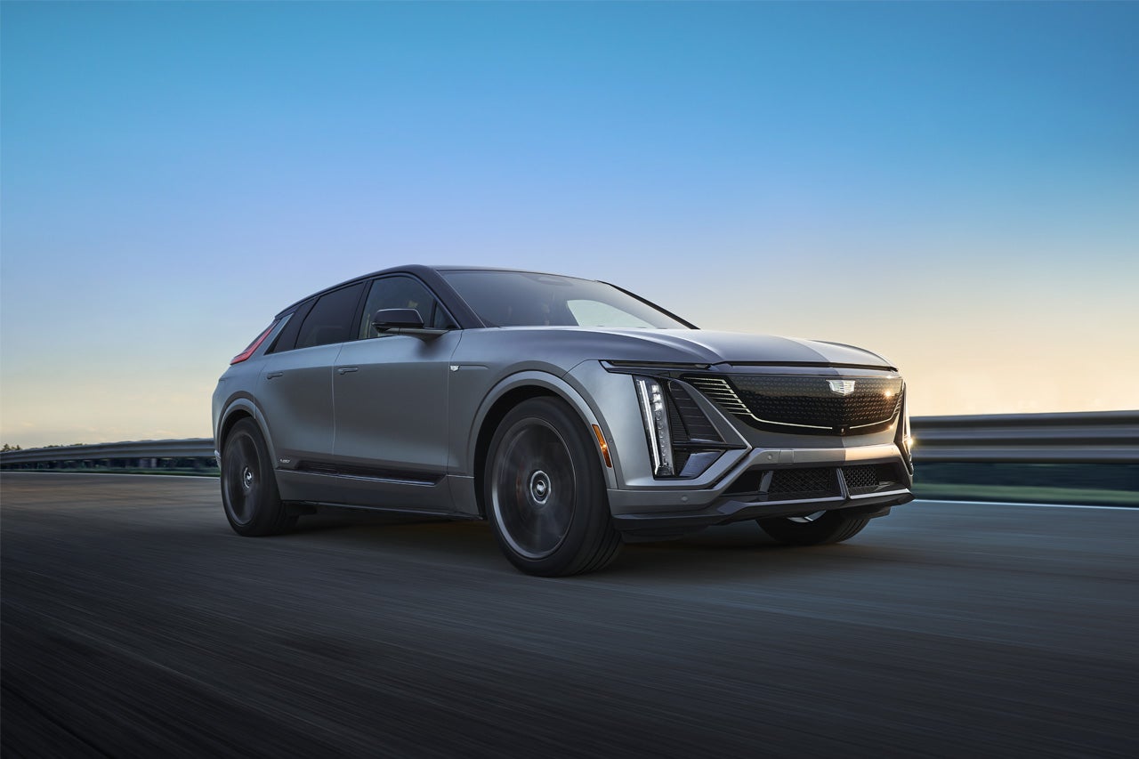 A Woman Utilizing the 2025 Cadillac XT5 Infotainment System Touch Screen